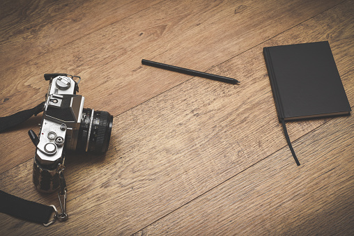 Retro style objects for blogging photography and writing on vintage wooden background