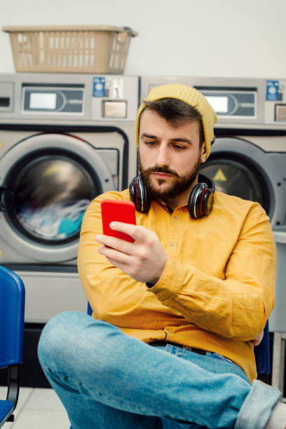 istock Young man washing his clothes 1186688314