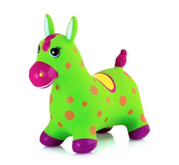 Photo of Bouncing inflatable horse toy for kids isolated on white background with shadow reflection. Rubber pony animal plaything for children. Great toy for balance, core muscle strengthening, and fun.