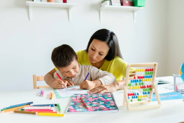 istock Mother Helping Her Little Son With Homework 1186689613