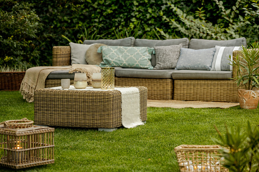 Modern lounge with wicker furniture in the garden