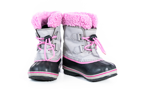 Little girl pink and gray warm and waterproof winter boots on a white background.