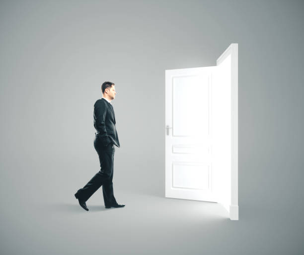 istock Businessman walking to opened door. 1186702658