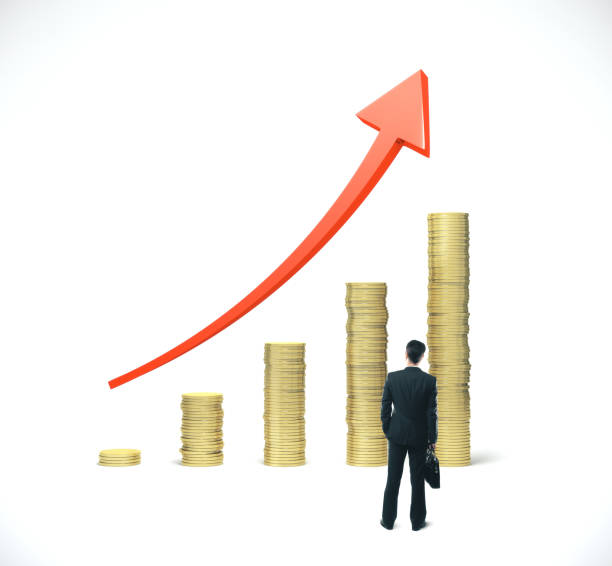 istock Businessman looking on gold coins chart 1186703254