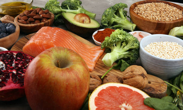 istock Healthy food clean eating selection: fish, fruit, vegetable, cereal, leaf vegetable on rustic background 1186703687
