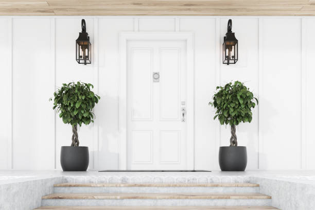 istock White front door of white house with trees, stairs 1186705492