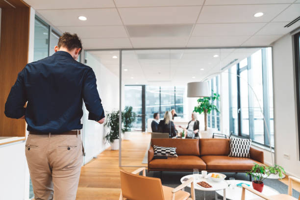 istock Businessman walking into a meeting in a modern office 1186705622