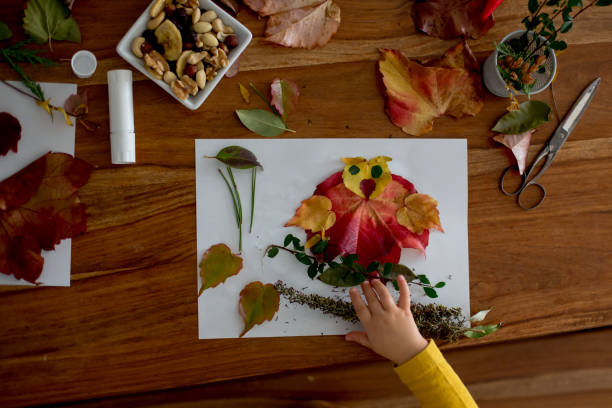 istock Sweet child, toddler boy, applying leaves using glue 1186707986