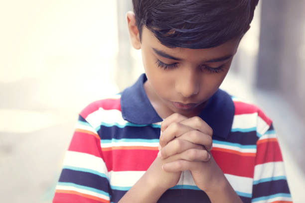 istock Indian Cute Little Boy Praying 1186708229