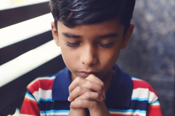 istock Indian Cute Little Boy Praying 1186708266