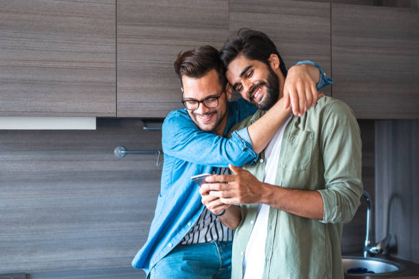 istock Happy gay couple at home 1186709940