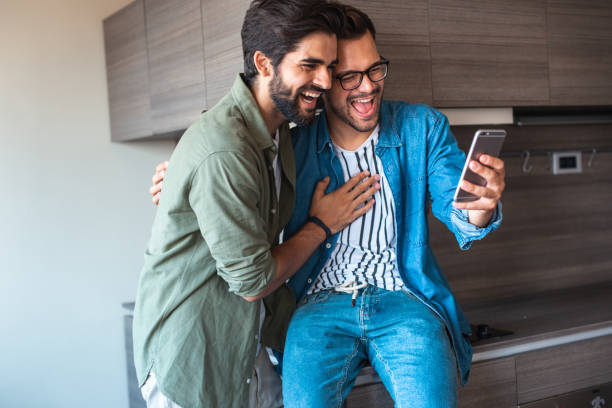istock Smiling gay couple at home 1186709985