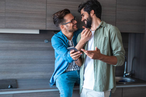 istock Happy gay couple at home 1186709987