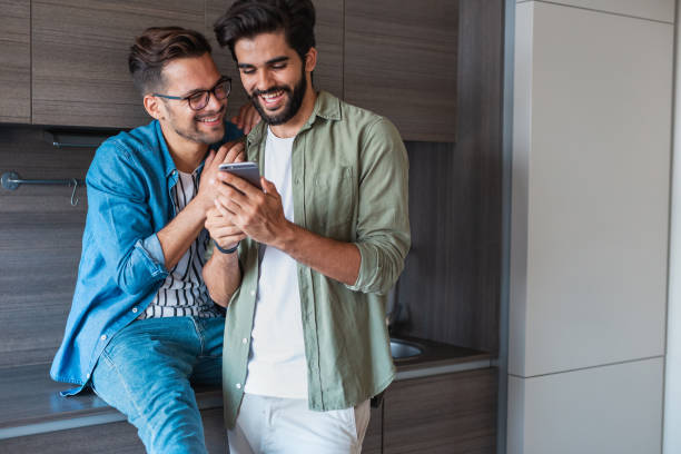 istock Smiling gay couple at home 1186710099