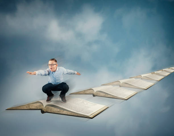 istock Kid flying in the sky with books. 1186711842
