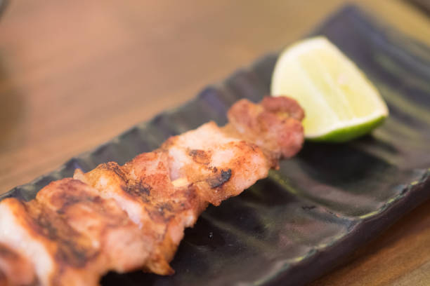 istock Barbecue pork with lemon on black plate 1186712284