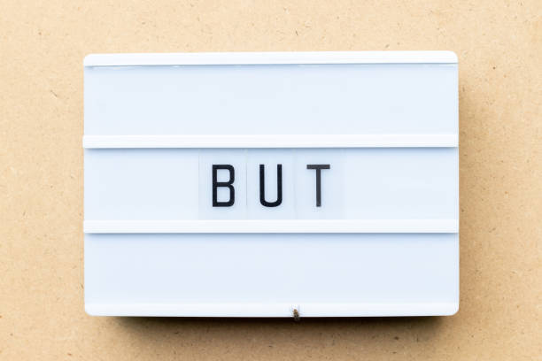 istock White lightbox with word but on wood background 1186716477