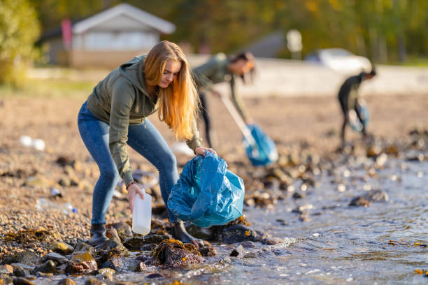 istock Young volunteers cleaning beach on sunny day 1186716875
