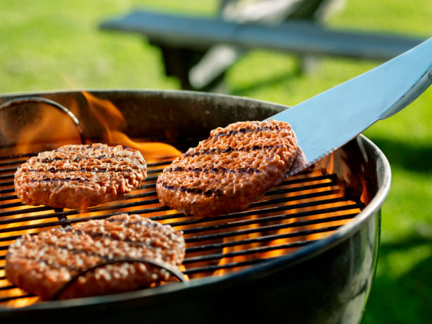 cooking burgers on a backyard bbq - barbecue grill barbecue burger hamburger imagens e fotografias de stock