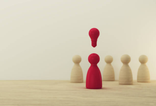 istock Outstanding red people standing with light bulb icon out from the crowd. Human resource, Talent management, Recruitment employee, Successful business team leader concept. 1186720771