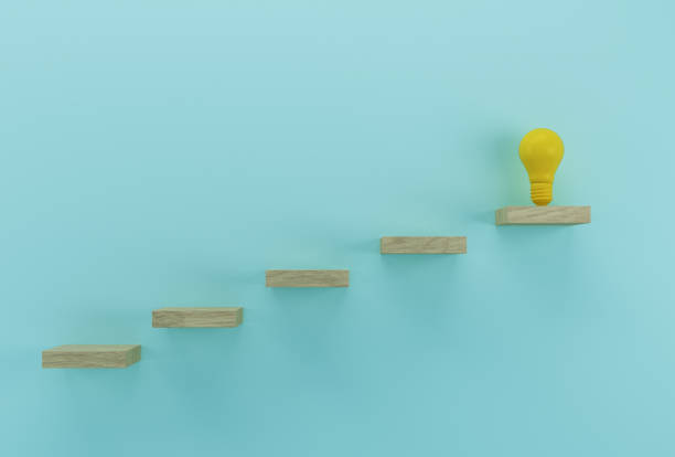 istock Creative idea and innovation. Light bulb revealing an idea outstanding on wood background 1186721319