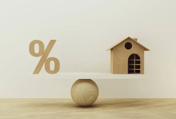 Photo of Percentage symbol icon and house scale in equal position. financial management concept : depicts short term borrowing for a residence.
