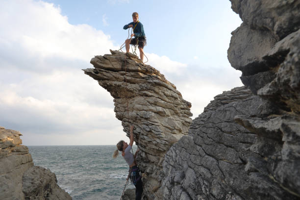 Waves crash on cliffs below