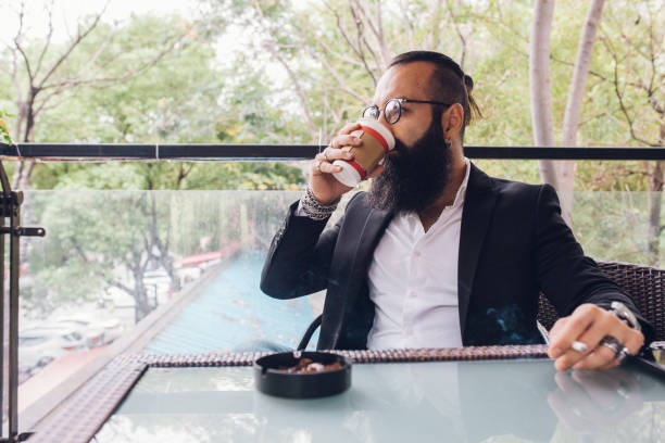 istock Modern businessman having coffee and a cigarette 1186725072