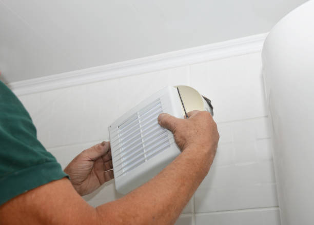 istock Handyman installing new bath vent fan, ventilation system in the house bathroom . Bath fan repair, installation. 1186726231