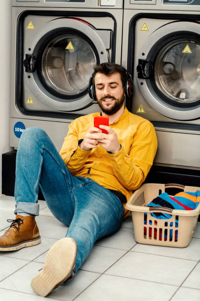 istock Young man washing his clothes 1186726610