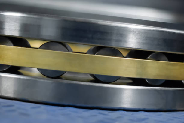 blurred industrial background with a fragment of a roller bearing close-up