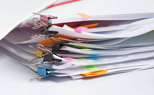 istock Pile of printed paper documents with color clips 1186727703