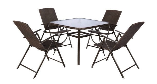 istock Cast iron dining table and four rattan dining chairs on a white background 1186728738