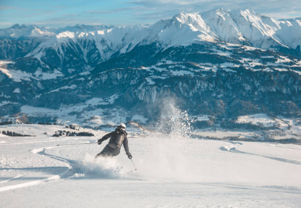 Woman skiing in Laax, Switzerland. Woman free skiing in fresh powder in Laax, Switzerland. top of ski mountain stock pictures, royalty-free photos & images