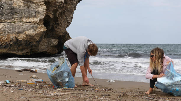 istock Friends pick up garbage on beach 1186729986
