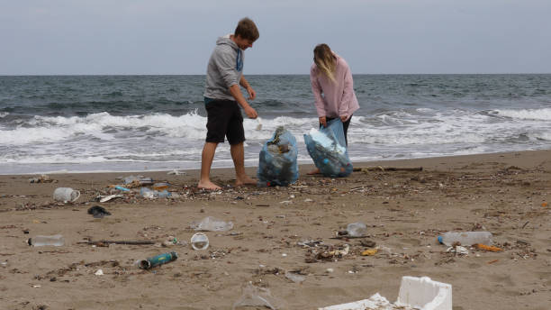 istock Friends pick up garbage on beach 1186730298