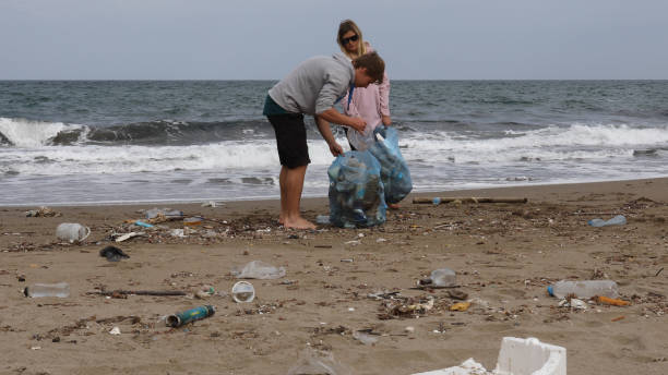 istock Friends pick up garbage on beach 1186730427
