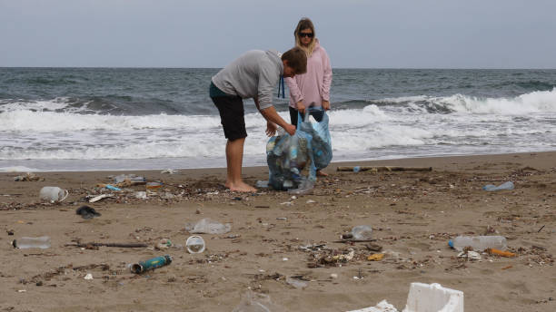 istock Friends pick up garbage on beach 1186731057