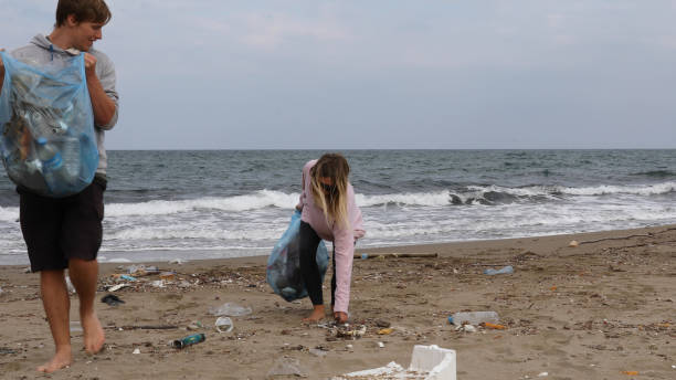 istock Friends pick up garbage on beach 1186731066