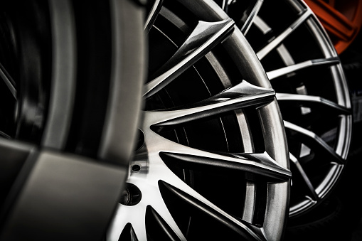 Close-up of modern shiny alloy wheel rims in a automovite retail shop.