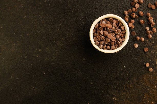 chocolate drops (black or milk chocolate, sweet ingredient) menu concept. food background. copy space. top view - choc chip imagens e fotografias de stock