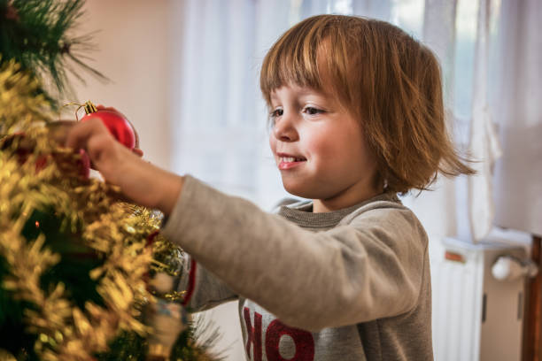 istock Cute little girl decorating Christmas tree. 1186735530