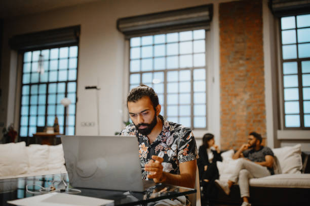 istock Young businessman looking stressed during a late night in a modern office 1186749385