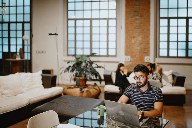 istock Man working at home while roommates talking in the background 1186749391