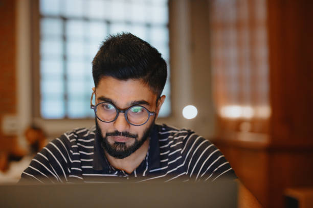 istock Young businessman looking stressed during a late night in a modern office 1186749422