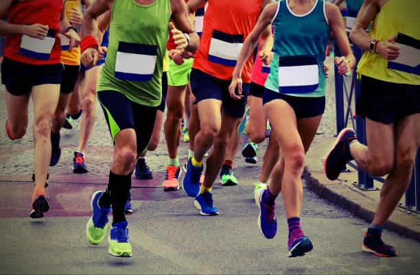 istock athletes runninng on the road with old toned effect 1186749673