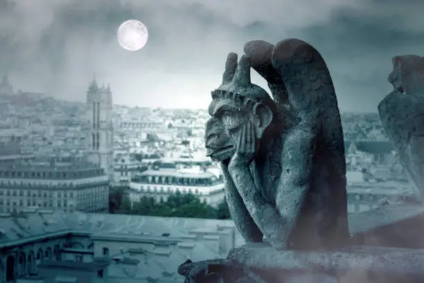 Foggy Night and Moon Light over The Gargoyles of Notre Dame in Paris