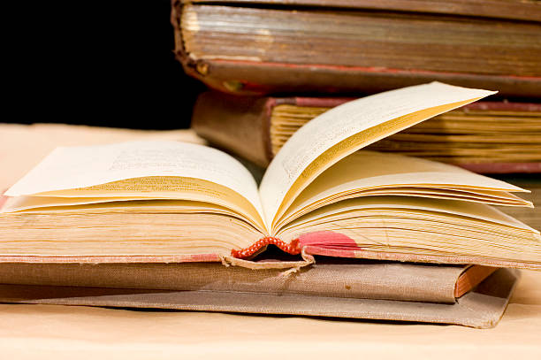 istock Pile of old books on black background 118675085