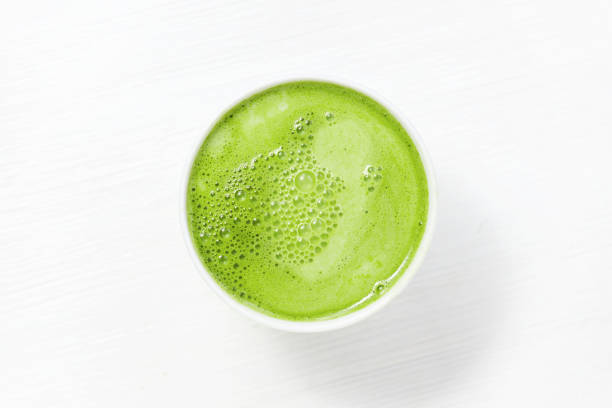 istock Cup of matcha tea with milk on the white table 1186750909