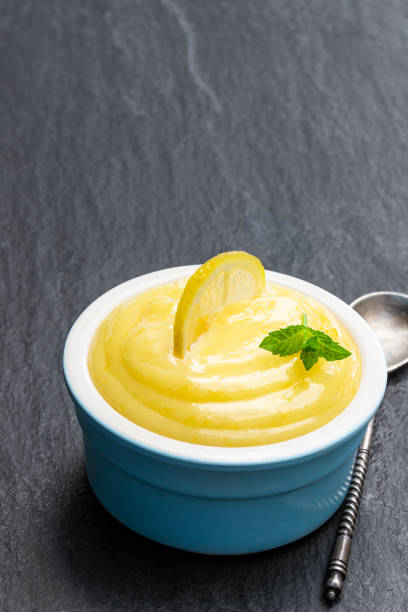 istock Homemade Lemon Curd in blue ceramic bowl on black stone table 1186750941